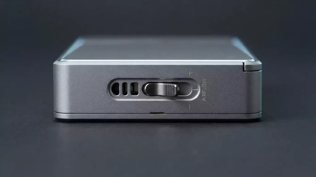 Close-up view of the mechanical adjustable airflow toggle switch on the back of an authentic pod system, demonstrating hardware control settings.