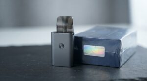 how to spot fake vape hardware -- genuine pod system and sealed authentication label on deep slate surface before verification