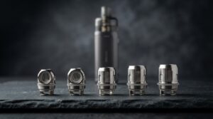 Vaporesso GTX coil guide -- five GTX mesh coils arranged in a row by resistance on a deep slate surface, from 0.15 ohm to 1.2 ohm, with a Vaporesso GTX ONE kit behind them in soft focus