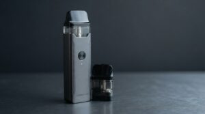 Vaporesso XROS 5 Mini review pod kit in matte black finish on deep slate surface with XROS 0.8 ohm pod alongside